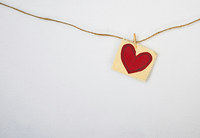 Red paper heart clipped to a string